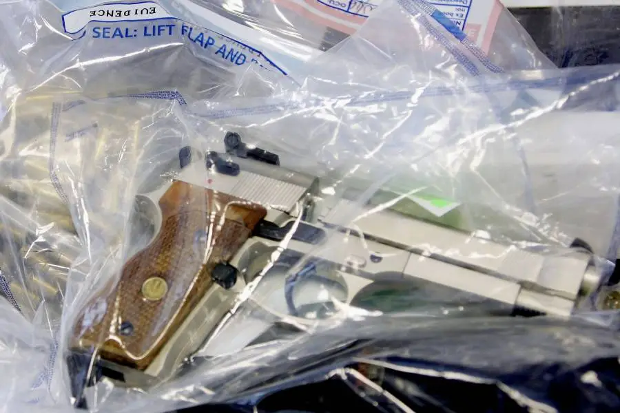 Evidence bag with handgun—representing grand theft firearm felony in Florida