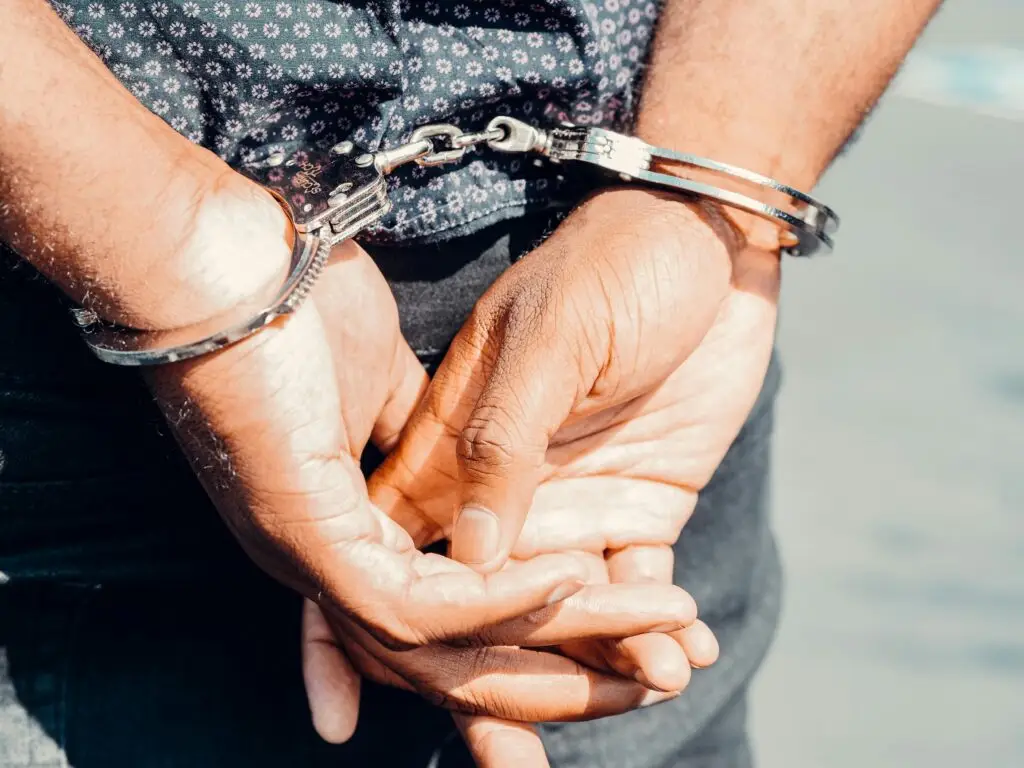 Hands in handcuffs, symbolizing arrest related to grand theft charges in Florida, emphasizing legal consequences and criminal defense.