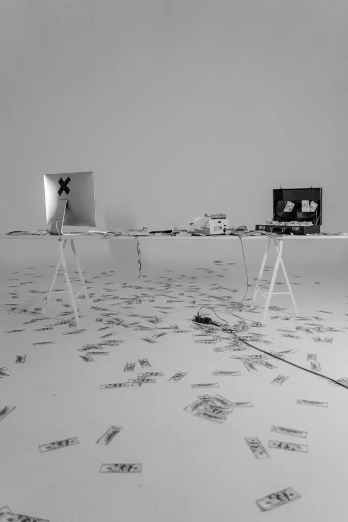 Laptop, cash, and wiring in a suspicious setup — visual metaphor for wire fraud investigation in Florida