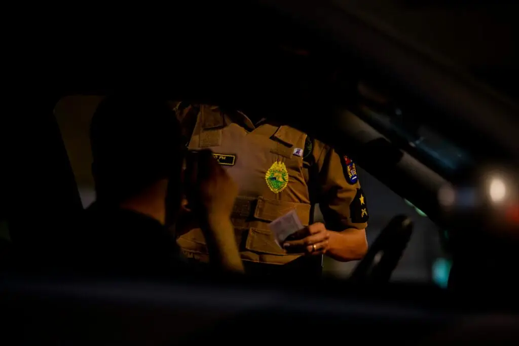 Fort Lauderdale police vehicle conducting DUI traffic stop on a palm-lined road at dusk