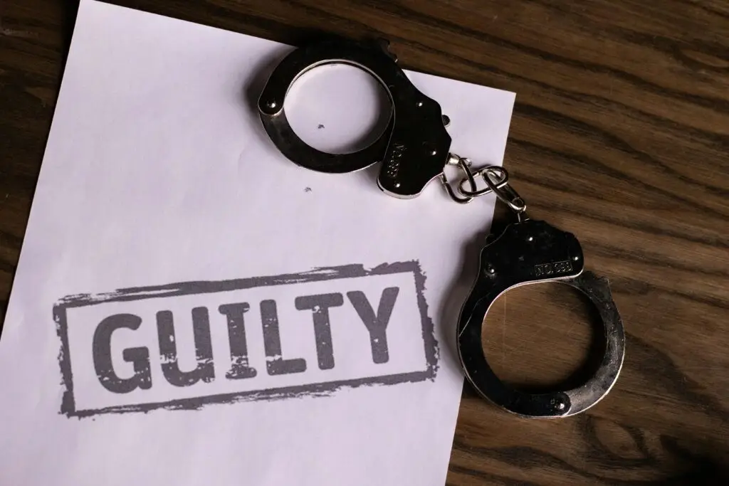Handcuffs placed on a document stamped “GUILTY,” symbolizing the seriousness of aggravated battery charges in Florida.